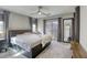 Spacious bedroom with a ceiling fan, carpeted floor, and a sliding door to the outside at 7061 Tilligerry St, North Las Vegas, NV 89084