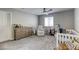 Bright bedroom with a ceiling fan, carpeted floor, and a window for natural light at 7061 Tilligerry St, North Las Vegas, NV 89084