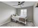 Nice bedroom with a ceiling fan, carpeted floor, and a window for natural light at 7061 Tilligerry St, North Las Vegas, NV 89084