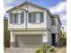 Charming two-story home with a well-maintained front yard and gray shutter details at 7061 Tilligerry St, North Las Vegas, NV 89084
