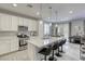 Contemporary kitchen with stainless steel appliances and a spacious island, complemented by modern pendant lighting at 7061 Tilligerry St, North Las Vegas, NV 89084
