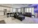 Inviting living space with an open floor plan connecting a modern kitchen to a cozy seating area at 7061 Tilligerry St, North Las Vegas, NV 89084