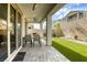 Backyard patio with an artificial lawn and desert landscaping, seating available at 7061 Tilligerry St, North Las Vegas, NV 89084
