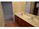 Bathroom features a double sink vanity with tile flooring and a shower and tub at 7518 Luna Del Rey St, Las Vegas, NV 89123