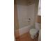 Well-lit bathroom with tile floors, a bathtub, and standard toilet; simple and clean design at 7518 Luna Del Rey St, Las Vegas, NV 89123
