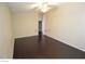 Spacious bedroom featuring dark hardwood floors, neutral paint, and a ceiling fan at 7518 Luna Del Rey St, Las Vegas, NV 89123