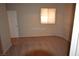 Cozy bedroom with neutral carpet, window, and door creating a blank canvas at 7518 Luna Del Rey St, Las Vegas, NV 89123
