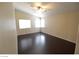 Bright bedroom with hardwood floors, neutral walls, vaulted ceiling, and dual windows at 7518 Luna Del Rey St, Las Vegas, NV 89123