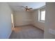Comfortable bedroom with ceiling fan, window, and neutral carpet creating a blank canvas at 7518 Luna Del Rey St, Las Vegas, NV 89123