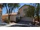 Charming two-story home featuring a tiled roof, desert landscaping, and an attached two-car garage at 7518 Luna Del Rey St, Las Vegas, NV 89123