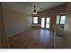 Spacious living room with neutral walls, tile flooring, a ceiling fan, and access to a patio at 7518 Luna Del Rey St, Las Vegas, NV 89123