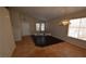 Inviting living room featuring neutral walls, tile flooring, and a decorative light fixture at 7518 Luna Del Rey St, Las Vegas, NV 89123