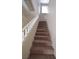 Carpeted staircase with white railing leads to upper level, enhancing home's cozy appeal at 7518 Luna Del Rey St, Las Vegas, NV 89123