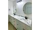Modern bathroom with double vanity, white marble countertops, stylish lighting, and round mirrors at 7615 Paso Robles Ave, Las Vegas, NV 89113