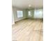 Spacious room featuring sleek wood floors, natural light, and a mirrored wall at 7615 Paso Robles Ave, Las Vegas, NV 89113