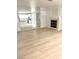 Open-concept living area featuring wood floors, a fireplace, and a clear view into the modern kitchen at 7615 Paso Robles Ave, Las Vegas, NV 89113