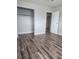 Spacious bedroom featuring wood-look floors and closet at 781 Buol Rd, Pahrump, NV 89048