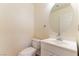 Cozy half bathroom featuring a sleek vanity, modern fixtures, and a well-placed mirror at 7923 Homer Ct, Las Vegas, NV 89139