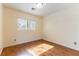 Bright bedroom featuring wood floors and natural light from a window at 7923 Homer Ct, Las Vegas, NV 89139