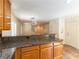 Stylish kitchen with granite counters, wooden cabinets, and an open layout connecting to the living area at 7923 Homer Ct, Las Vegas, NV 89139