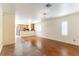 Open living space with hardwood flooring, plantation shutters, and seamless transition into adjacent kitchen at 7923 Homer Ct, Las Vegas, NV 89139