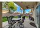 Inviting outdoor space with stylish patio furniture and lush synthetic grass at 8128 Devils Canyon St, North Las Vegas, NV 89085