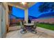 Inviting outdoor space with stylish patio furniture and lush synthetic grass at 8128 Devils Canyon St, North Las Vegas, NV 89085
