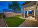Beautiful backyard features manicured lawn, covered patio with fans and stylish outdoor furniture at 8128 Devils Canyon St, North Las Vegas, NV 89085
