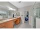Bathroom with granite countertops, double vanity, tile floors, and frameless glass shower at 8128 Devils Canyon St, North Las Vegas, NV 89085