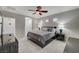 Bedroom boasts a ceiling fan, carpeted floors, neutral walls, and three windows at 8128 Devils Canyon St, North Las Vegas, NV 89085