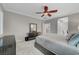 Bedroom features a ceiling fan, neutral walls, carpeted floors and a dark dresser at 8128 Devils Canyon St, North Las Vegas, NV 89085