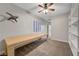 Cozy bedroom with built-in shelving, ceiling fan, and shutters at 8128 Devils Canyon St, North Las Vegas, NV 89085