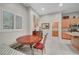 Bright breakfast nook with wood table and window with shutter shades next to the kitchen at 8128 Devils Canyon St, North Las Vegas, NV 89085