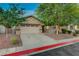 View of a well-maintained single-story home with a spacious two-car garage and lovely front yard landscaping at 8128 Devils Canyon St, North Las Vegas, NV 89085