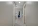 Hallway between bedroom and bathroom showcases open doors and tile flooring at 8128 Devils Canyon St, North Las Vegas, NV 89085