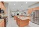 Open kitchen with stainless appliances, light wood cabinets, granite counters, and access to the backyard at 8128 Devils Canyon St, North Las Vegas, NV 89085