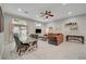 Open-concept living space with tile flooring, ceiling fan, dining table, and access to the outdoor patio at 8128 Devils Canyon St, North Las Vegas, NV 89085