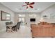 Bright living room with tile floors, a ceiling fan, dining area, and sliding glass doors to the outdoor space at 8128 Devils Canyon St, North Las Vegas, NV 89085