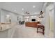 Open-concept living room featuring tile floors, a ceiling fan, recessed lighting, and access to the backyard at 8128 Devils Canyon St, North Las Vegas, NV 89085