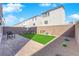 Private backyard featuring artificial turf, decorative landscaping, a brick paver patio, and a seating area at 8178 Eaton Hill St, Las Vegas, NV 89113