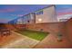 Inviting backyard featuring an artificial grass area, a hammock, and a charming brick fence at 8178 Eaton Hill St, Las Vegas, NV 89113