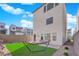 Backyard showcases low-maintenance desert landscaping, artificial turf, and a cozy hammock for relaxation at 8178 Eaton Hill St, Las Vegas, NV 89113