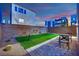 Cozy backyard with artificial turf, paver patio, and decorative desert landscaping at 8178 Eaton Hill St, Las Vegas, NV 89113