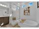 Bathroom features soaking tub, glass shower and decorative shelving at 8178 Eaton Hill St, Las Vegas, NV 89113