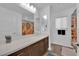 Bathroom features dual sinks, long counter, and decorative shower curtain at 8178 Eaton Hill St, Las Vegas, NV 89113