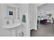 Stylish half-bathroom with a pedestal sink and modern fixtures, conveniently located near the living area at 8178 Eaton Hill St, Las Vegas, NV 89113