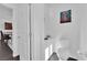 Clean, minimalist half-bathroom with a toilet and modern sink, enhanced by decorative art at 8178 Eaton Hill St, Las Vegas, NV 89113