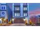 Striking three-story home featuring clean lines, large windows, and a private rooftop deck, set against a colorful sunset sky at 8178 Eaton Hill St, Las Vegas, NV 89113