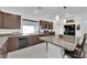 Modern kitchen featuring dark wood cabinets, granite counters, stainless steel appliances, and island with seating at 8178 Eaton Hill St, Las Vegas, NV 89113