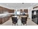 Elegant kitchen with dark cabinetry, granite countertops, and black appliances, perfect for cooking and entertaining at 8178 Eaton Hill St, Las Vegas, NV 89113